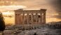 The Parthenon on the Acropolis of Athens silhouetted against a warm sunset sky