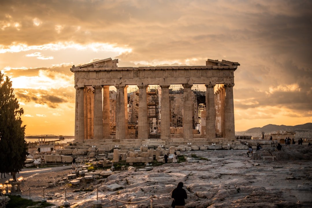 The Parthenon on the Acropolis of Athens silhouetted against a warm sunset sky