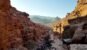 Travelers hiking through the sandstone canyon toward the Monastery at Petra, Jordan