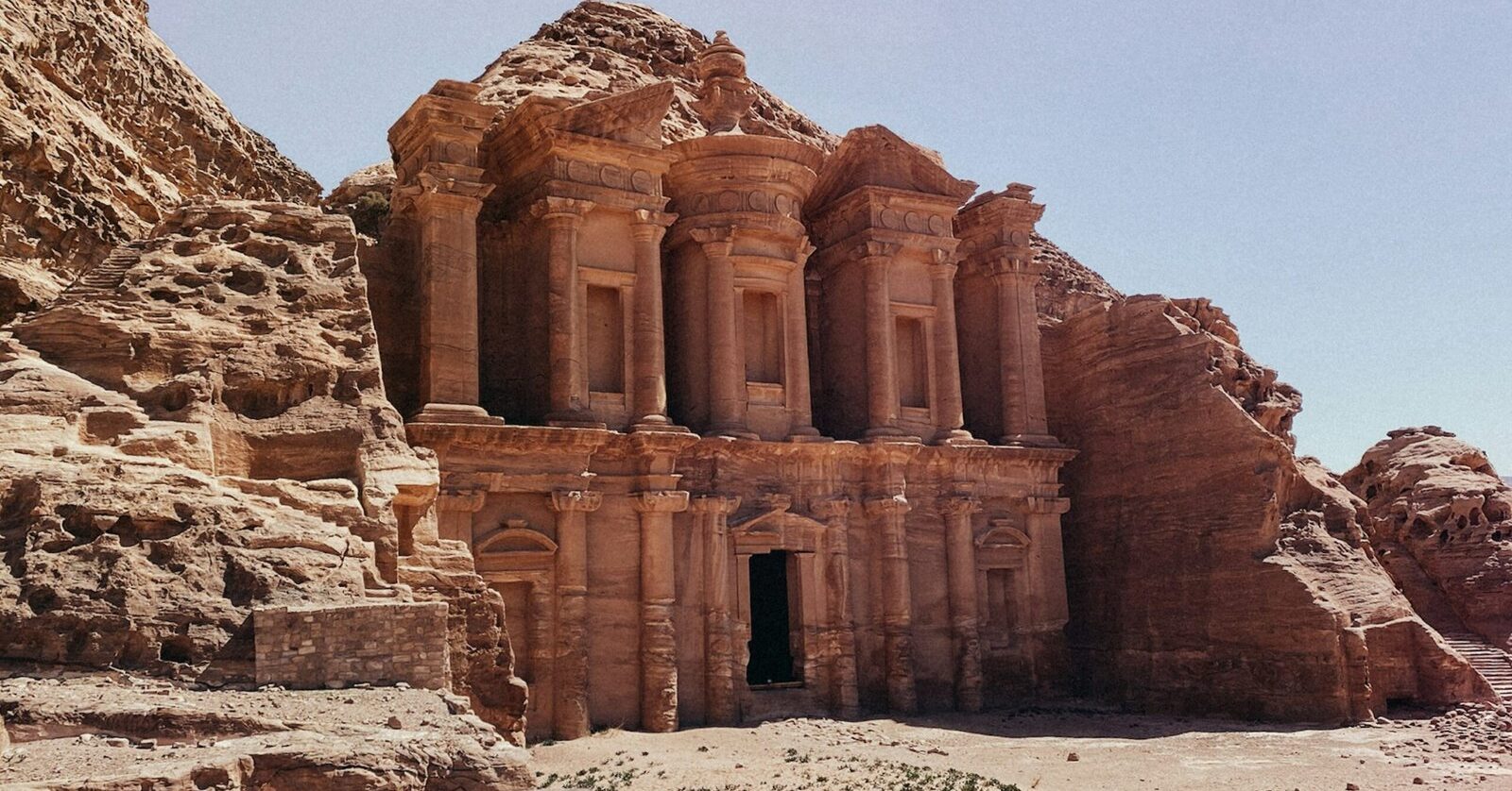 Al-Deir Monastery monumental rock-cut facade carved into red sandstone at Petra, Jordan