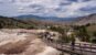 Visitors walking along boardwalks through the geothermal terraces of Yellowstone National Park