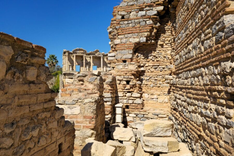 Ancient stone ruins at Ephesus beneath a vivid blue sky in Turkey