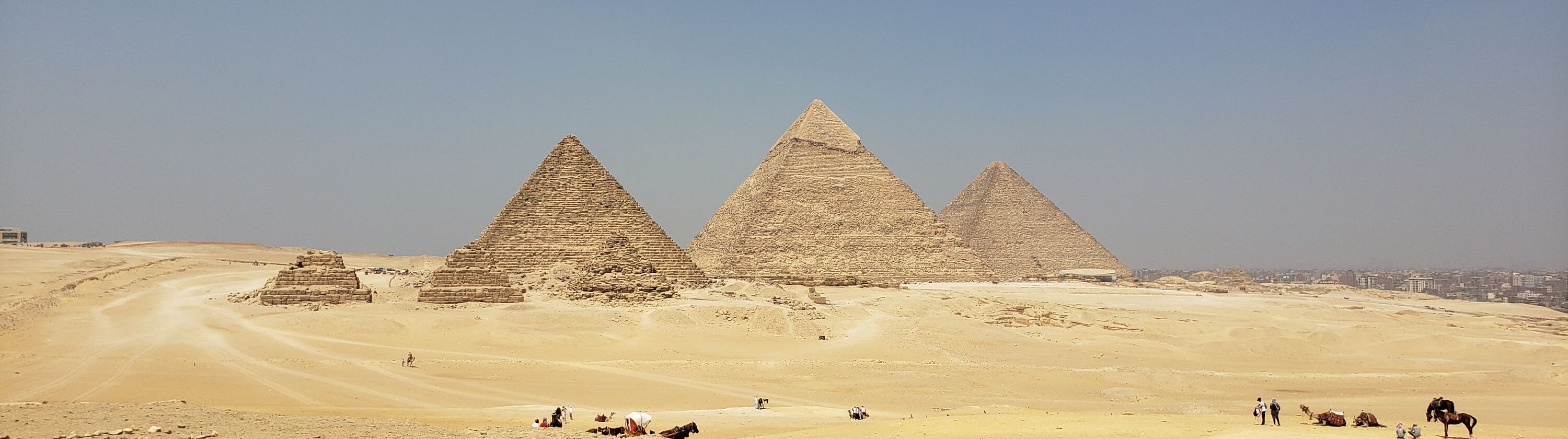 Sweeping view of the Giza pyramids beneath a clear blue sky in Egypt