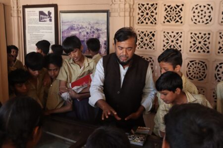 Guide speaking to a group during an educational museum visit