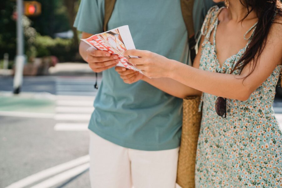Travelers using a paper map while exploring a city independently