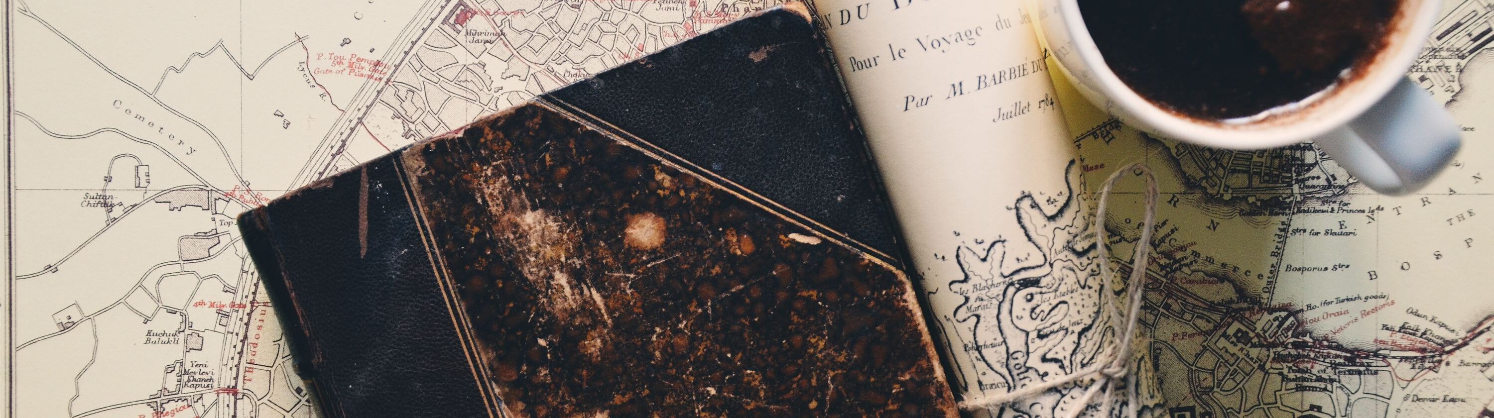 Vintage map of Constantinople with an old notebook and coffee arranged for travel research