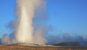 Old Faithful geyser erupting at sunrise in Yellowstone National Park